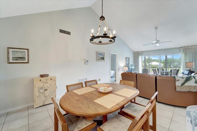 dining room with high vaulted ceiling, ceiling fan with notable chandelier, and light tile patterned floors