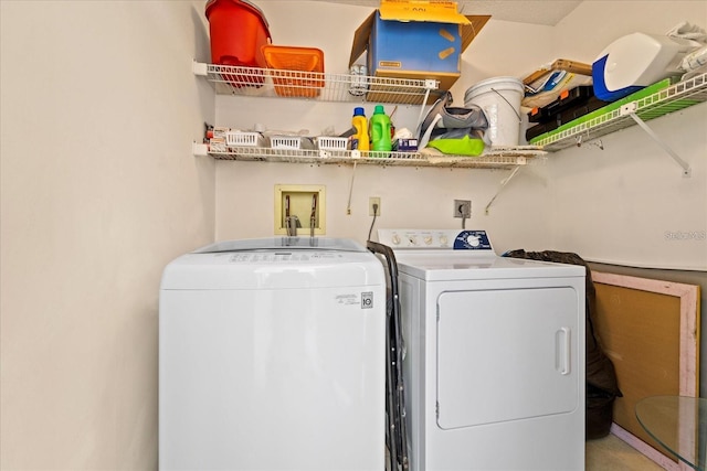 clothes washing area featuring separate washer and dryer