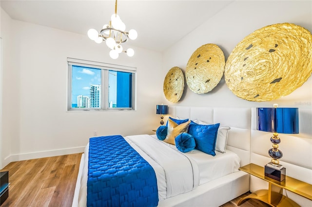 bedroom featuring hardwood / wood-style flooring and an inviting chandelier