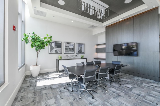 dining area featuring a raised ceiling