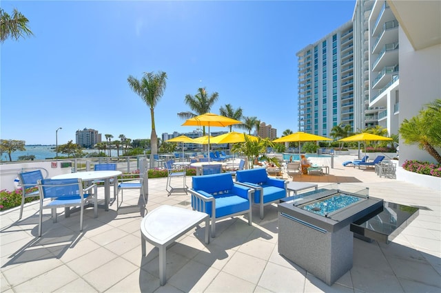 view of patio with an outdoor living space with a fire pit