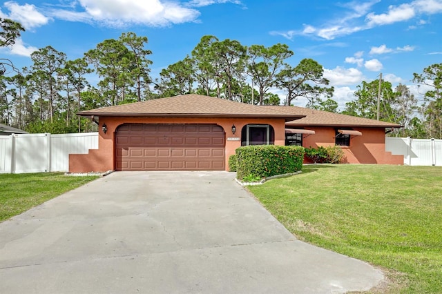 view of front of home with a front yard and a garage