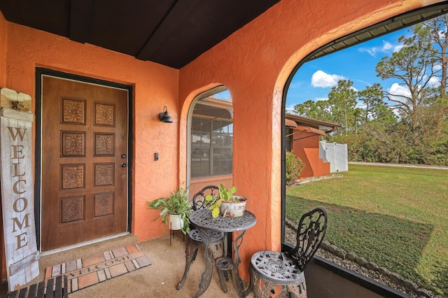 property entrance featuring a yard