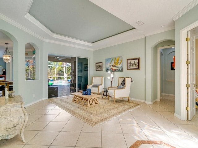 sitting room featuring light tile patterned floors, a tray ceiling, ceiling fan, and crown molding