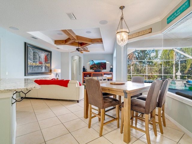 tiled dining area with ceiling fan with notable chandelier, a raised ceiling, crown molding, and coffered ceiling