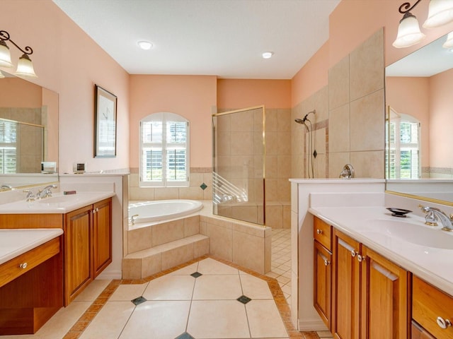 bathroom featuring vanity, independent shower and bath, and a healthy amount of sunlight