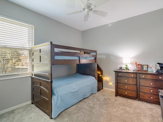 bedroom featuring ceiling fan and light carpet