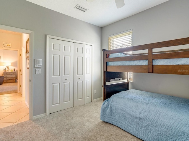 carpeted bedroom with ceiling fan and a closet