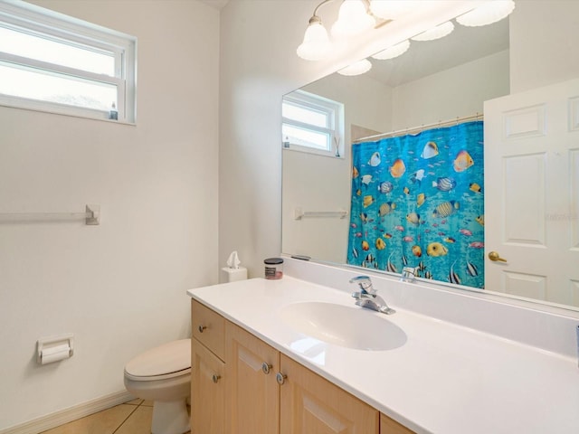 bathroom with toilet, vanity, tile patterned floors, and walk in shower