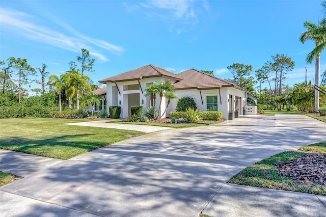 7003 River Club Blvd, Bradenton, FL 34202 - mediterranean / spanish home featuring driveway, stucco siding, a tiled roof, and a front lawn