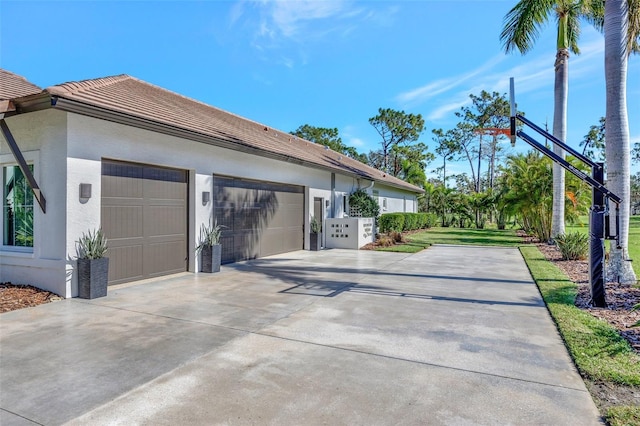 7003 River Club Blvd, Bradenton, FL 34202 - view of property exterior with driveway, stucco siding, and an attached garage