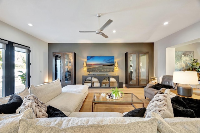 living room with wood-type flooring and ceiling fan