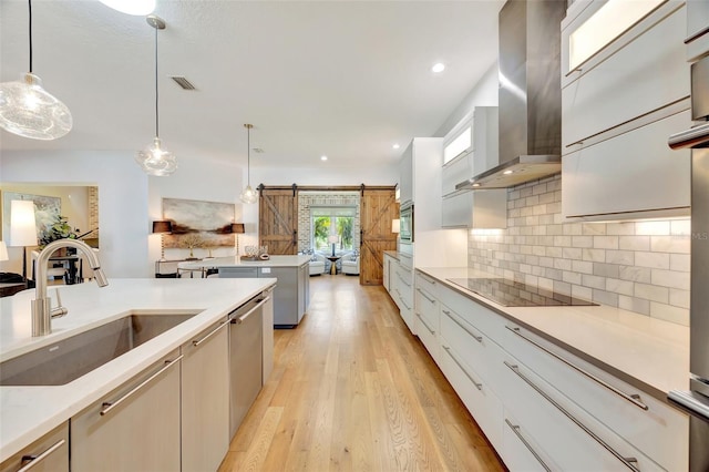 7003 River Club Blvd, Bradenton, FL 34202 - kitchen with a sink, wall chimney range hood, a barn door, black electric stovetop, and stainless steel dishwasher