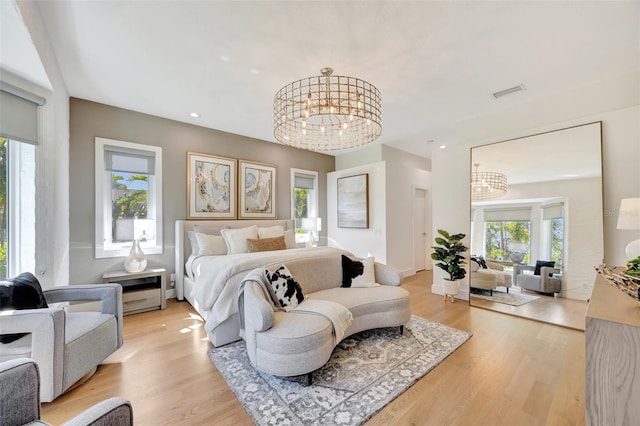 7003 River Club Blvd, Bradenton, FL 34202 - bedroom featuring a chandelier, multiple windows, light wood-style floors, and recessed lighting