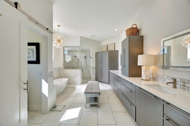 7003 River Club Blvd, Bradenton, FL 34202 - full bathroom featuring double vanity, tiled shower, a soaking tub, a chandelier, and tasteful backsplash