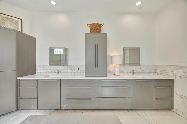 bathroom featuring tile patterned flooring, vanity, and backsplash