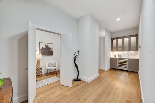 7003 River Club Blvd, Bradenton, FL 34202 - indoor wet bar with beverage cooler, light wood-style floors, decorative backsplash, baseboards, and recessed lighting
