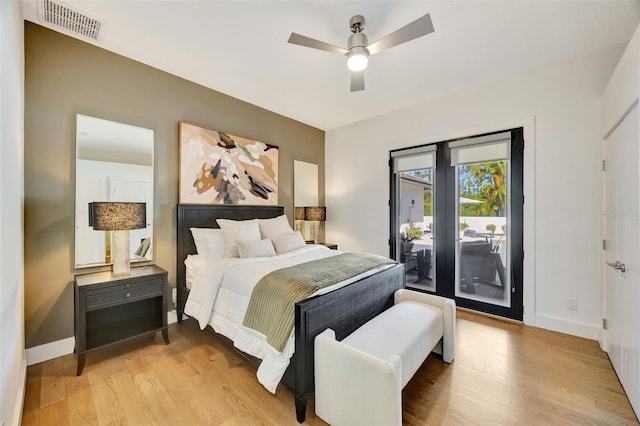 bedroom featuring ceiling fan, light hardwood / wood-style floors, and access to exterior