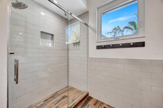 bathroom featuring wood-type flooring and a shower with door