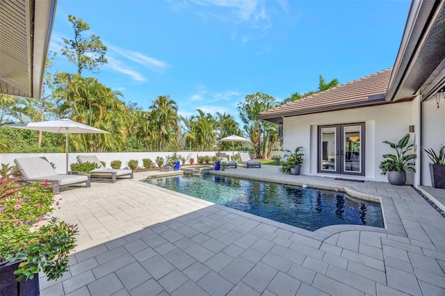 7003 River Club Blvd, Bradenton, FL 34202 - view of pool with a patio, french doors, a pool with connected hot tub, and a fenced backyard