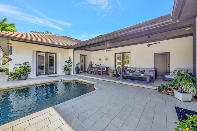 view of swimming pool featuring ceiling fan, a patio, and an outdoor living space