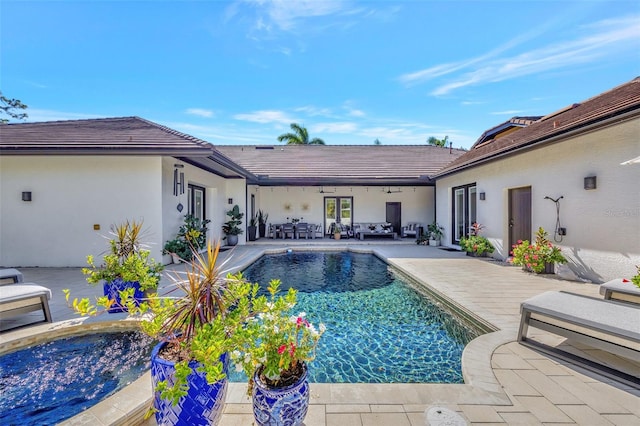 view of swimming pool with a hot tub and a patio area