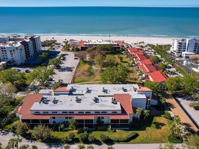 drone / aerial view featuring a water view and a beach view