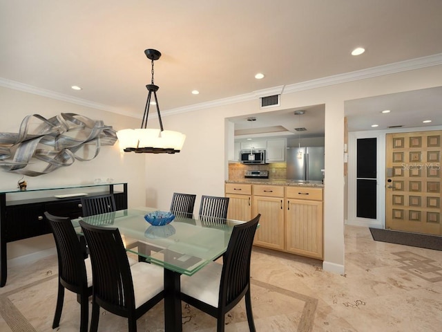 dining space with ornamental molding