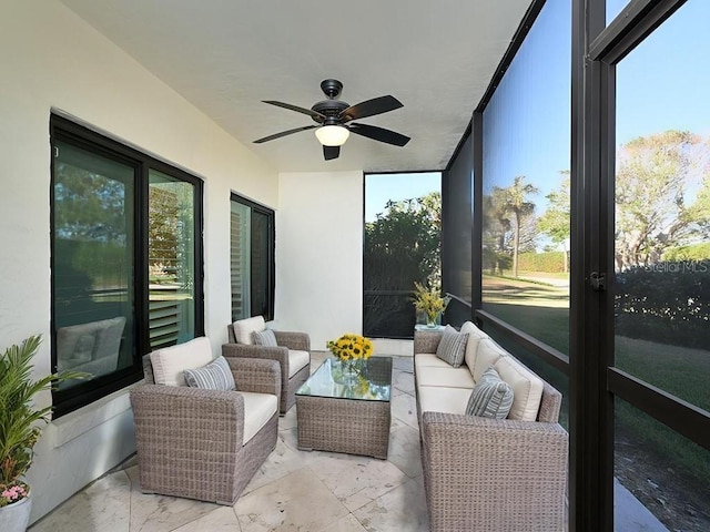 sunroom with a wealth of natural light and ceiling fan