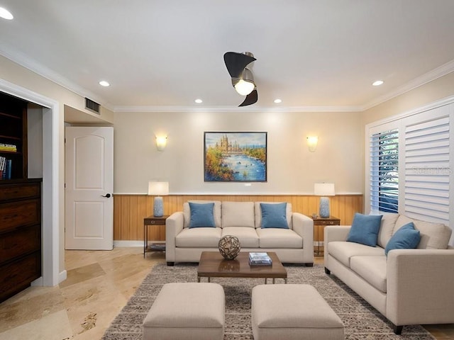 living room with wooden walls and ornamental molding