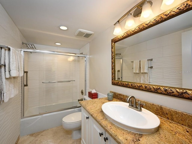 full bathroom featuring shower / bath combination with glass door, vanity, and toilet