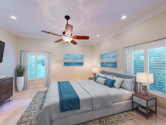 bedroom featuring multiple windows, ceiling fan, crown molding, and light hardwood / wood-style floors