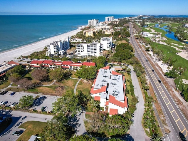 bird's eye view with a water view and a beach view