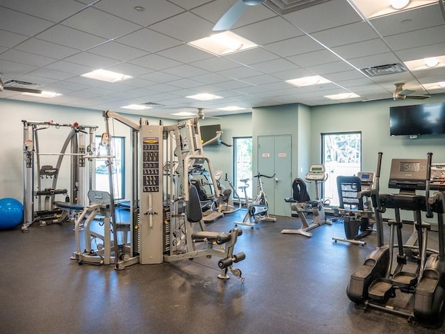 gym with a paneled ceiling