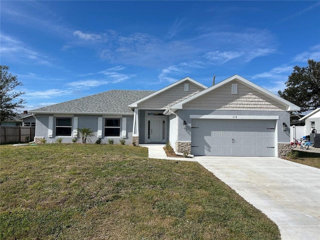 view of front facade featuring a front yard and a garage