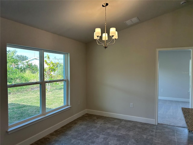 unfurnished room featuring an inviting chandelier