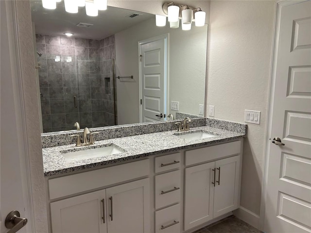 bathroom with vanity and a shower with door