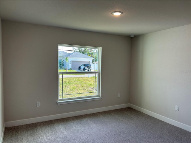 carpeted empty room featuring plenty of natural light