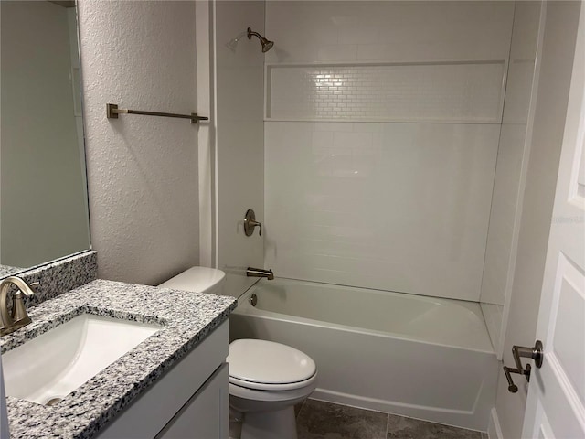 full bathroom featuring vanity, tiled shower / bath combo, and toilet