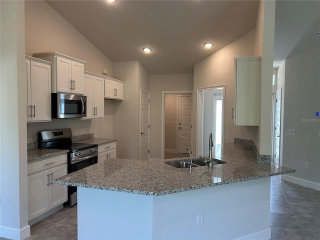 kitchen featuring kitchen peninsula, white cabinets, vaulted ceiling, and appliances with stainless steel finishes