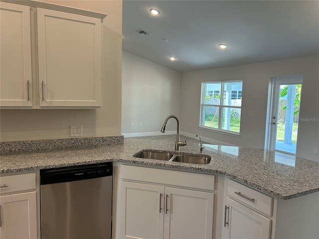 kitchen featuring stainless steel dishwasher, plenty of natural light, white cabinets, and sink