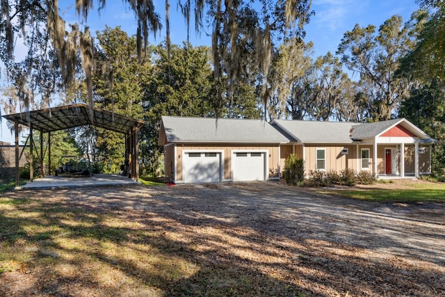 single story home with a carport, a garage, and a front yard