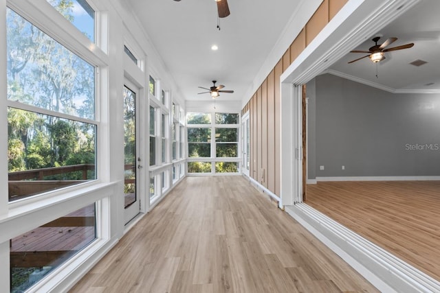 unfurnished sunroom featuring a wealth of natural light and ceiling fan