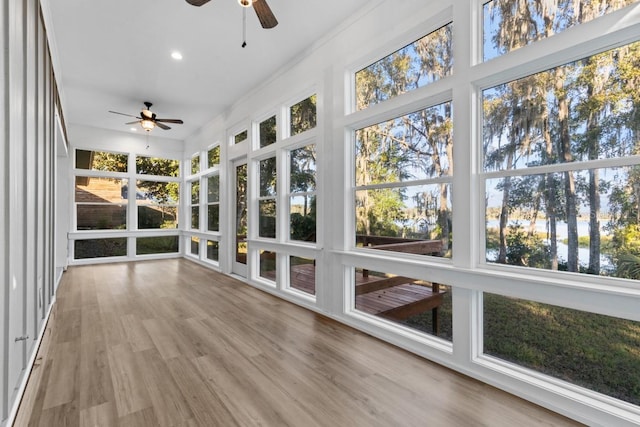 unfurnished sunroom featuring ceiling fan