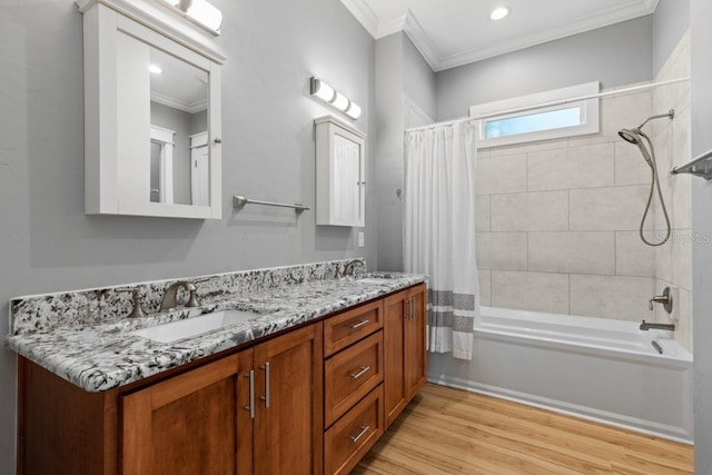 bathroom with crown molding, hardwood / wood-style floors, vanity, and shower / tub combo with curtain