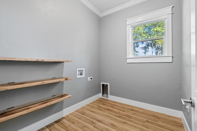 clothes washing area featuring hookup for a washing machine, light hardwood / wood-style flooring, electric dryer hookup, and crown molding