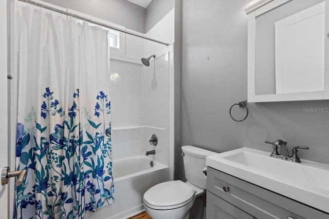 full bathroom with vanity, shower / bath combo, and toilet