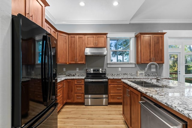 kitchen featuring light wood-type flooring, stainless steel appliances, ornamental molding, and sink