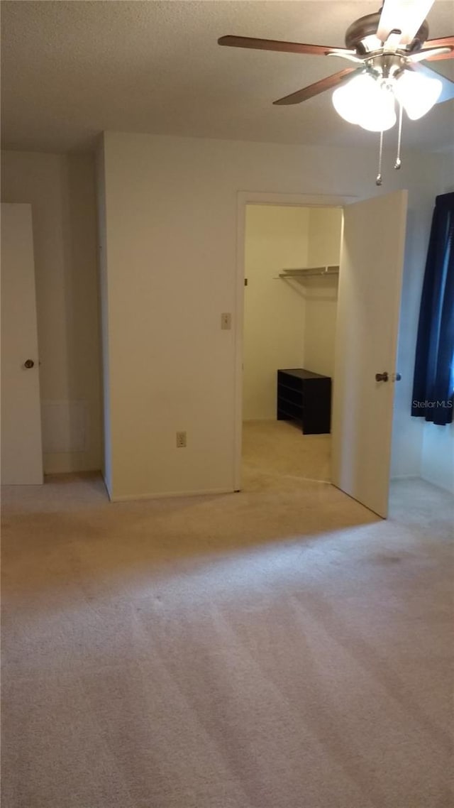 carpeted empty room with ceiling fan