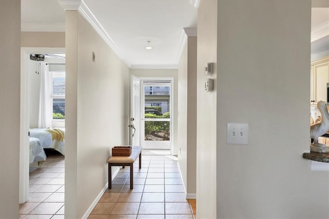 interior space featuring light tile patterned floors, baseboards, and crown molding